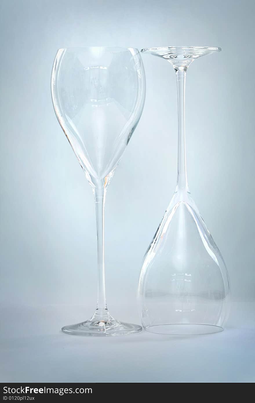 Shot of an empty glass wine with reflection on white background.