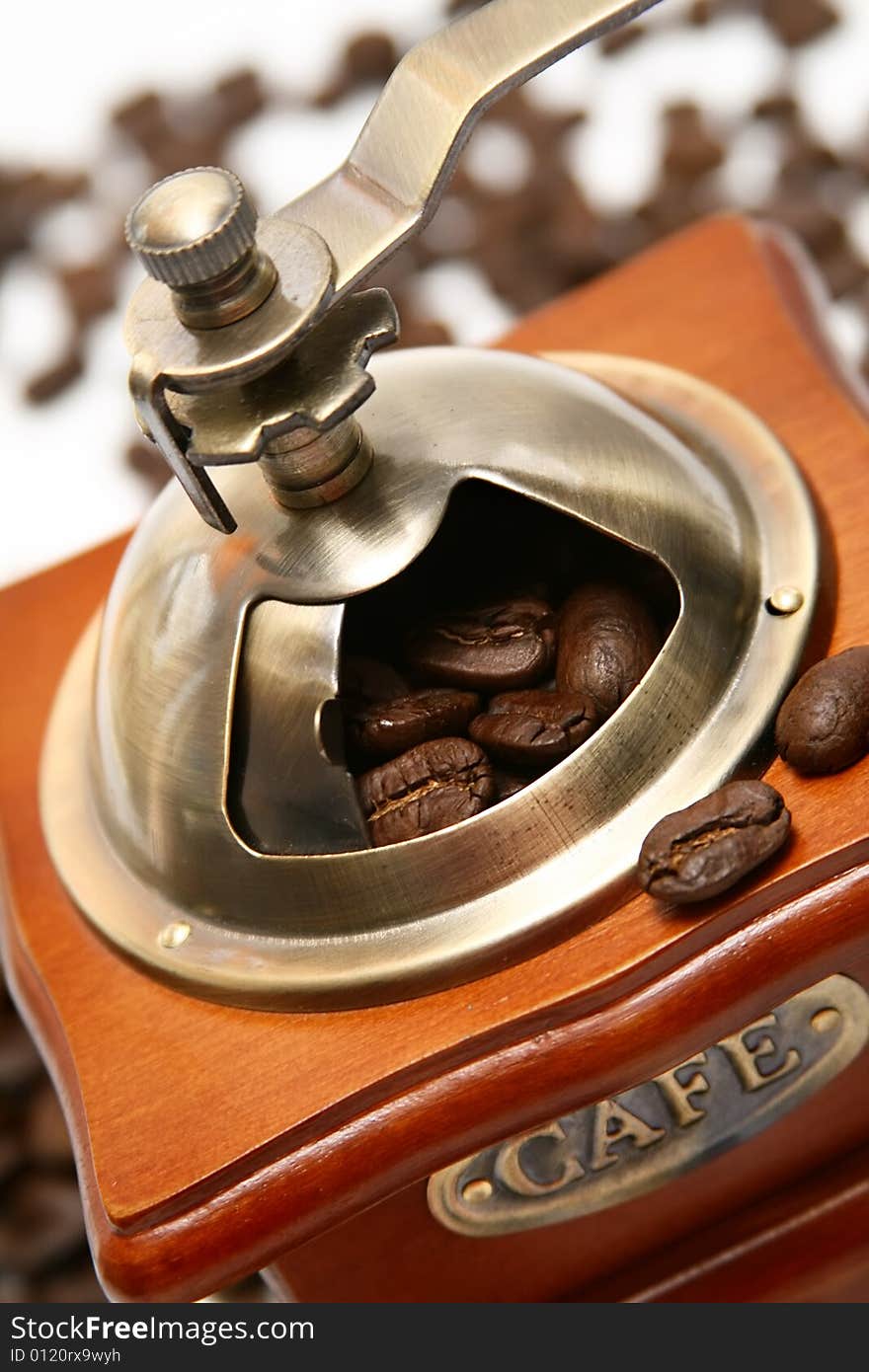 Old-fashioned coffee grinder with coffee beans