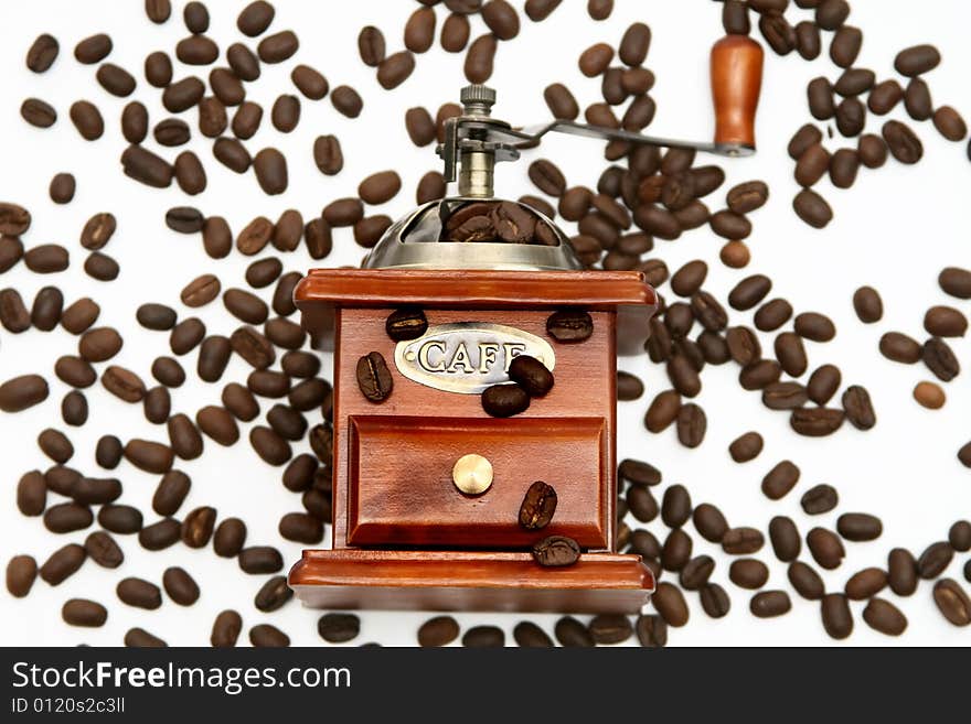 Old-fashioned coffee grinder with coffee beans