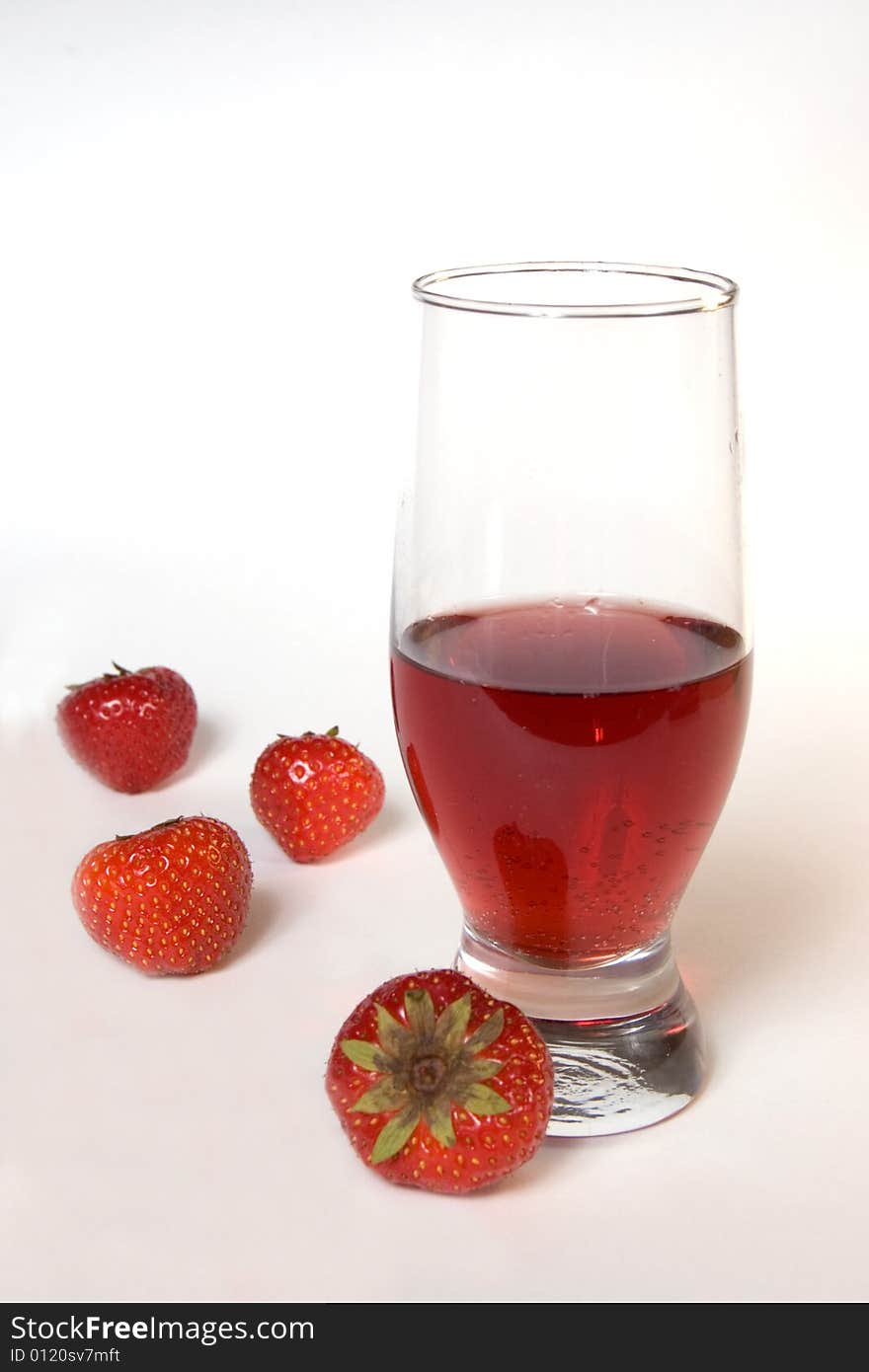 Red champagne in a glass with strawberries, isolated on white