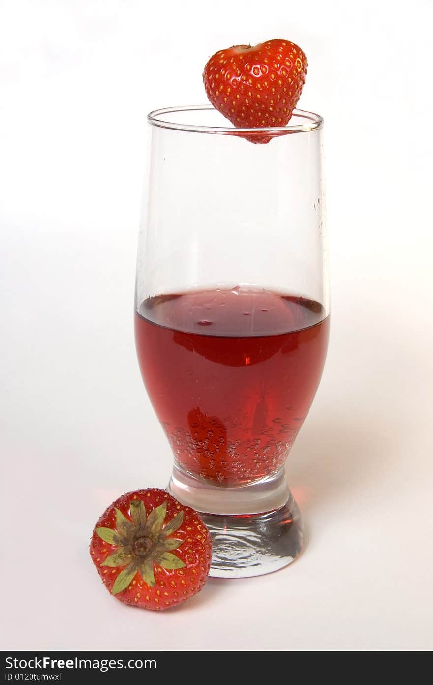 Red champagne in a glass with strawberries, isolated on white