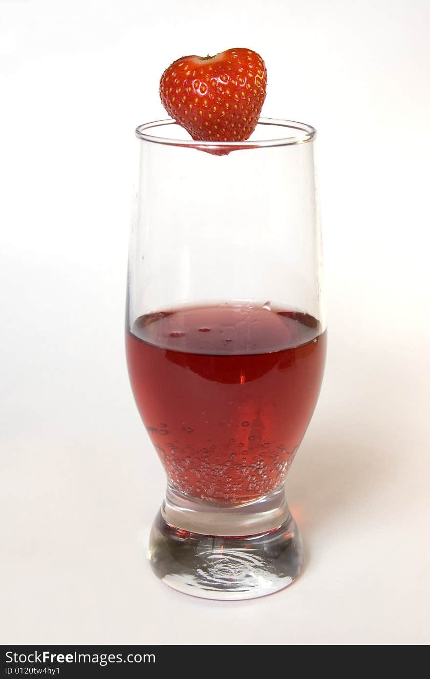 Red champagne in a glass with strawberry, isolated on white