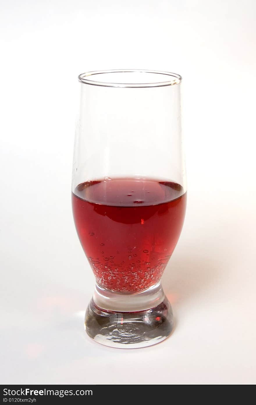 Red champagne in a glass, isolated on white