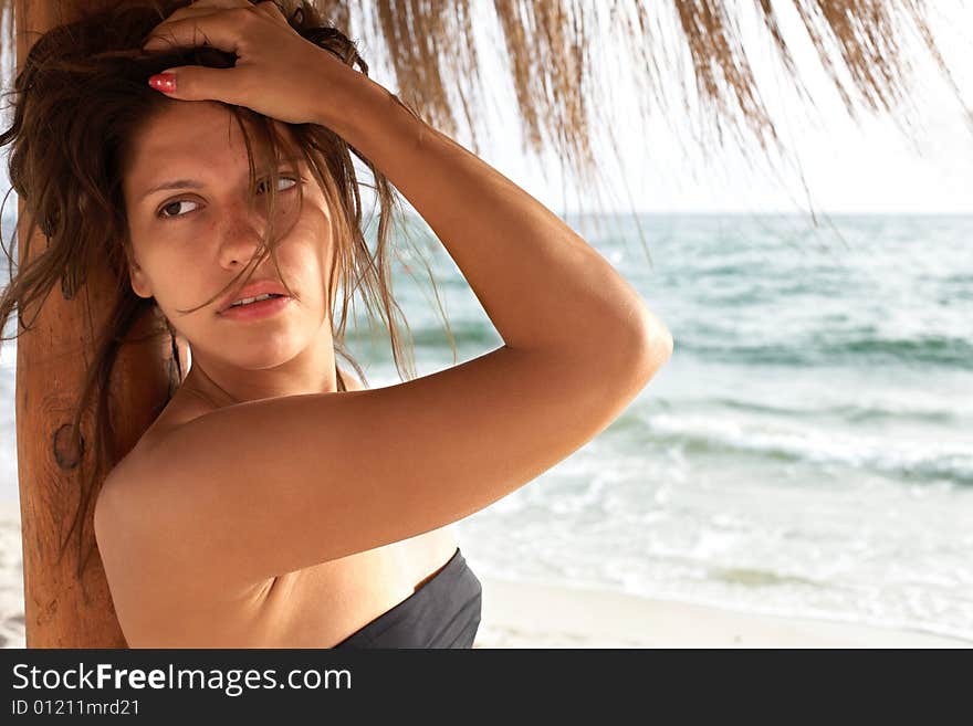 Young beautiful woman on beach near sea. Young beautiful woman on beach near sea