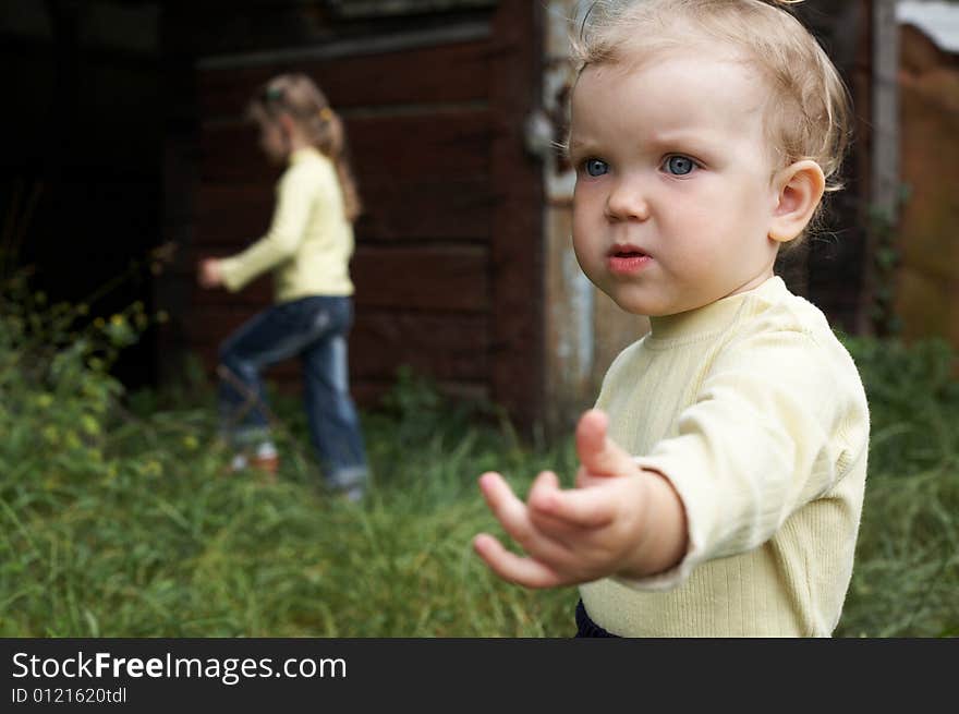 An image of little girl walking with her sister. An image of little girl walking with her sister