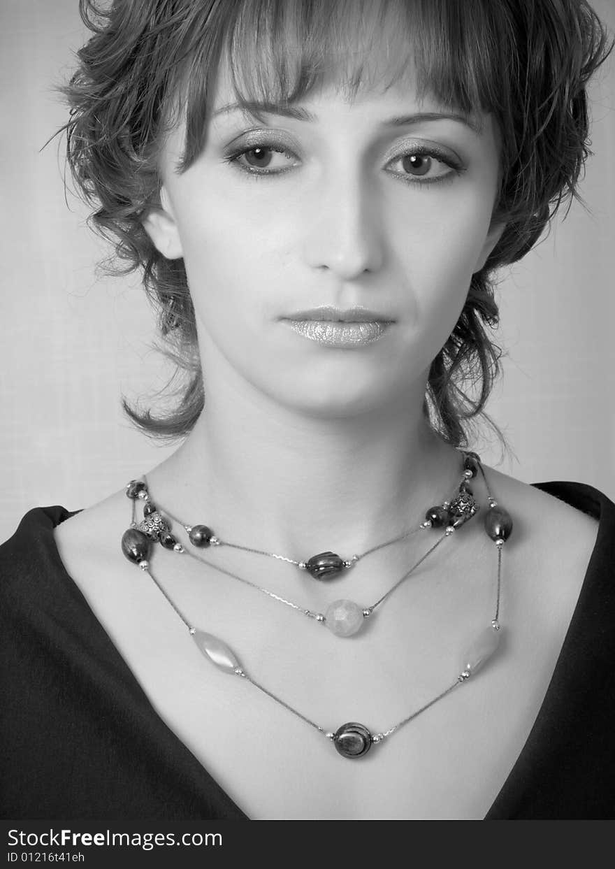 Beautiful girl with beads, black-and-white portrait