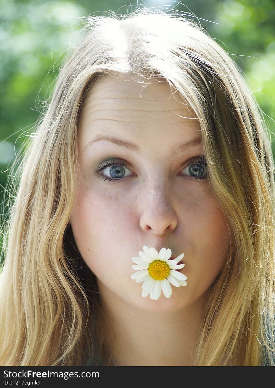 Expressive face of a model with flower in her mouth. Expressive face of a model with flower in her mouth