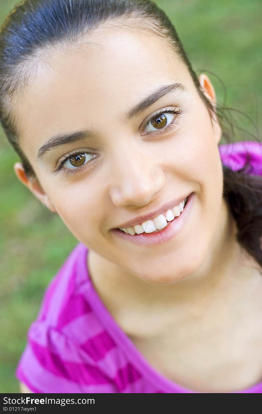 Portrait of happy young woman sitting outdoor