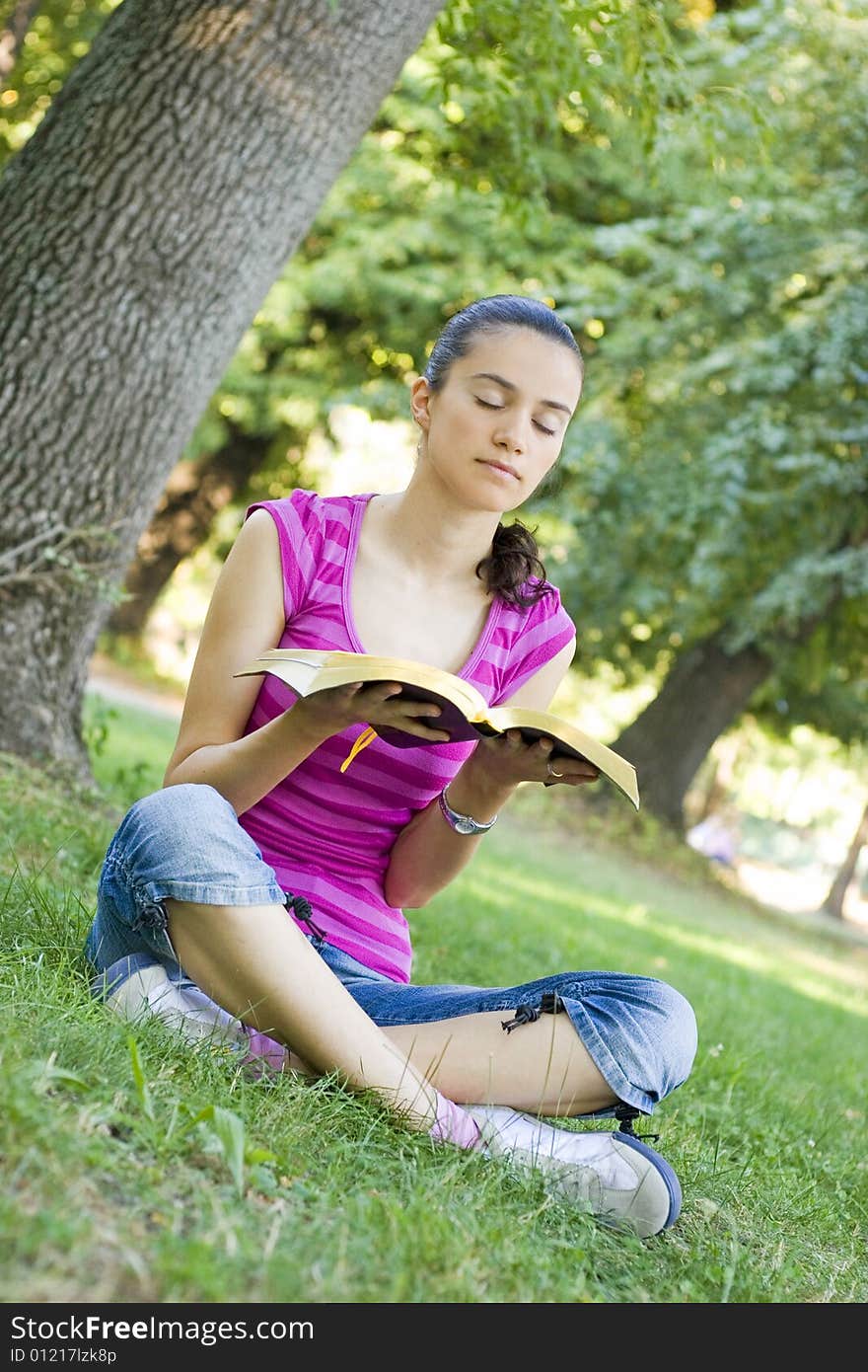 Young woman praying in park