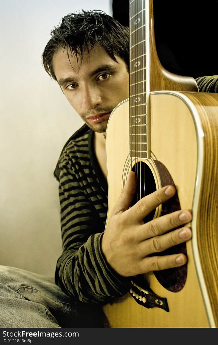 A young musician with a guitar