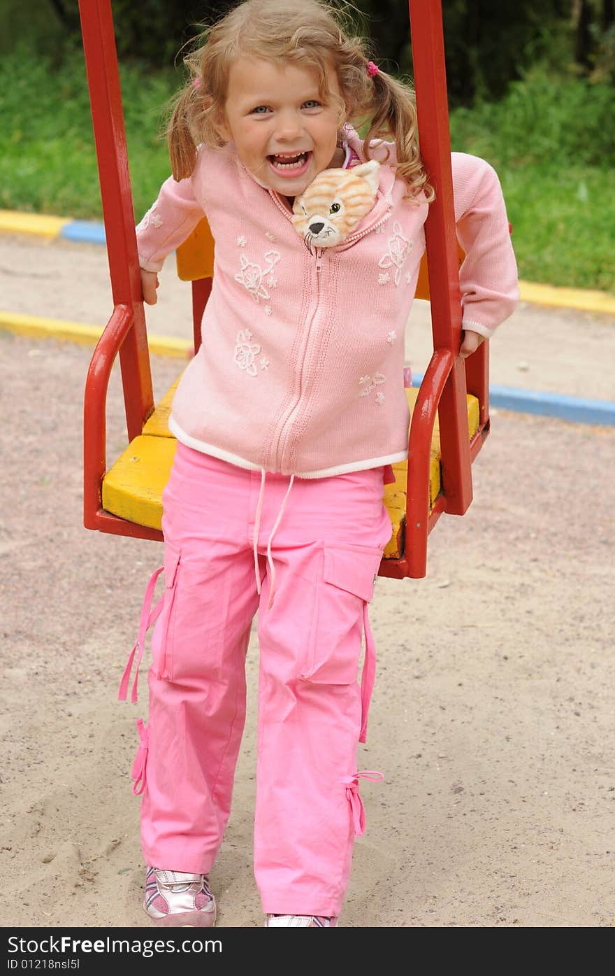 Young pretty girl on a swing