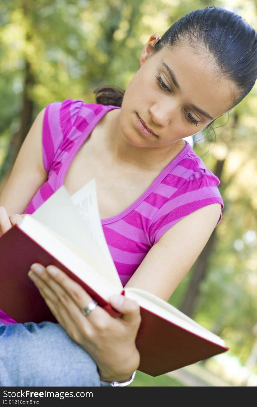 Young woman reading outdoor