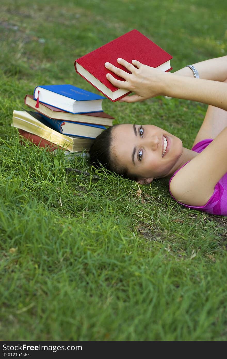 Young woman reading book outdoor. Young woman reading book outdoor