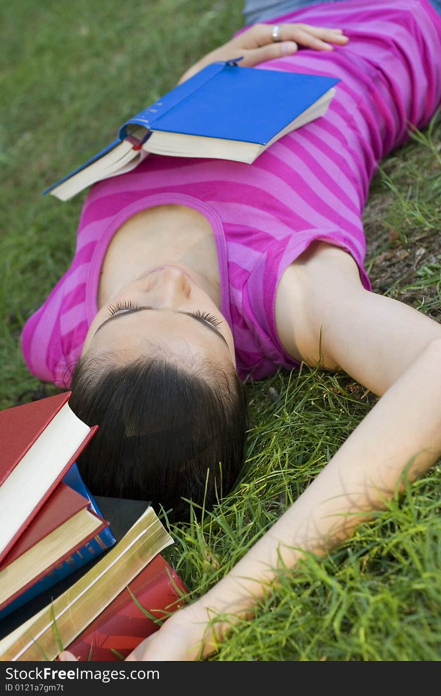 Young woman reading book outdoor. Young woman reading book outdoor