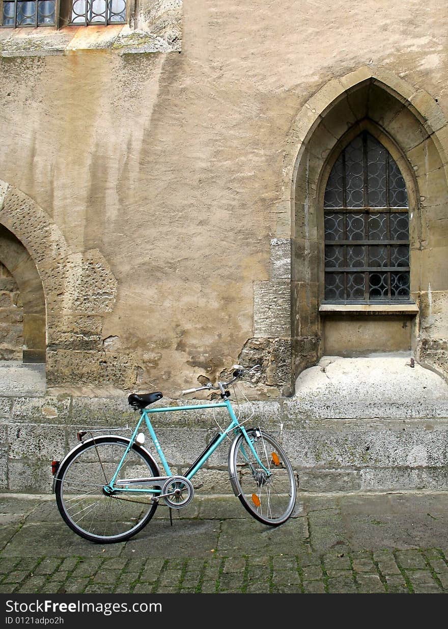 Beautiful old church, bike and cobblestone street in central Germany. Beautiful old church, bike and cobblestone street in central Germany.