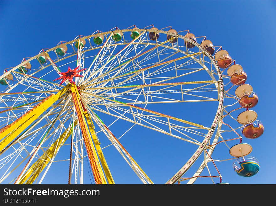 Observation wheel under blue sky