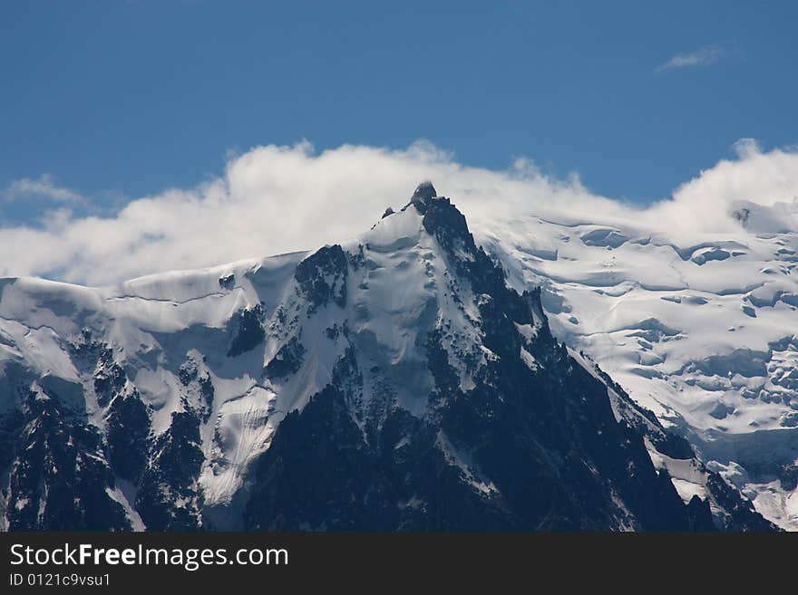 Clouds and snowfields on a peak of the Mont Blanc range. Clouds and snowfields on a peak of the Mont Blanc range