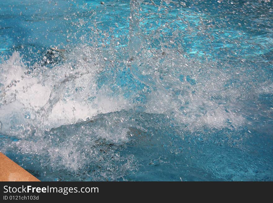 Person diving into a swimming pool. Person diving into a swimming pool