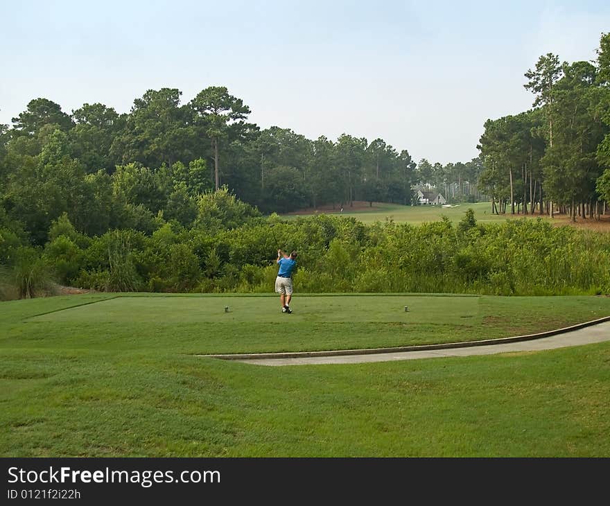 A golfer tees off on this beautiful Myrtle Beach, south Carolina golf course. A golfer tees off on this beautiful Myrtle Beach, south Carolina golf course.