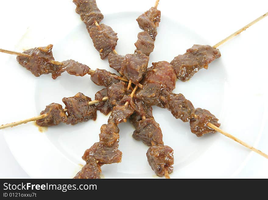 Satay or sate, dice-sized meat on bamboo skewers