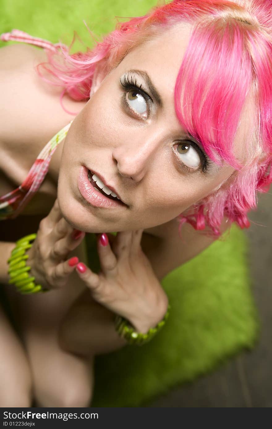 Closeup of Pretty Woman with Pink Hair on Green Rug