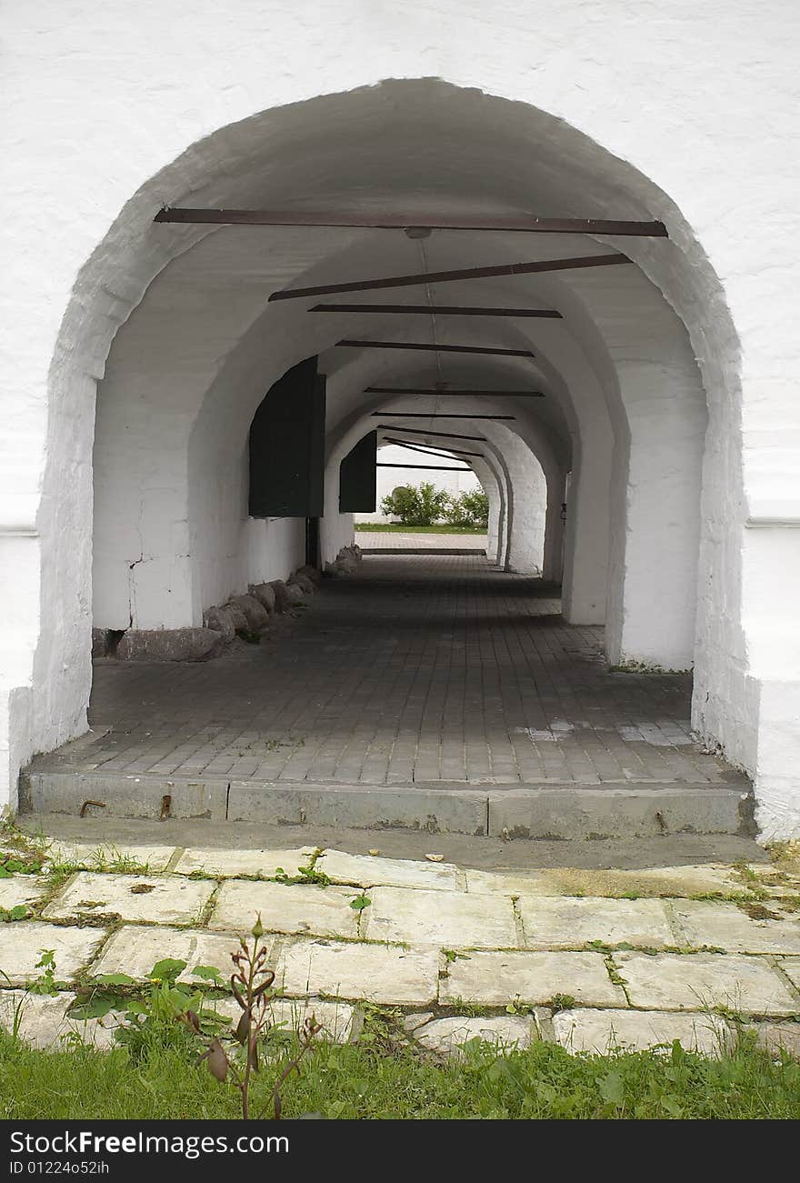 Down gallery in white ancient building. Down gallery in white ancient building