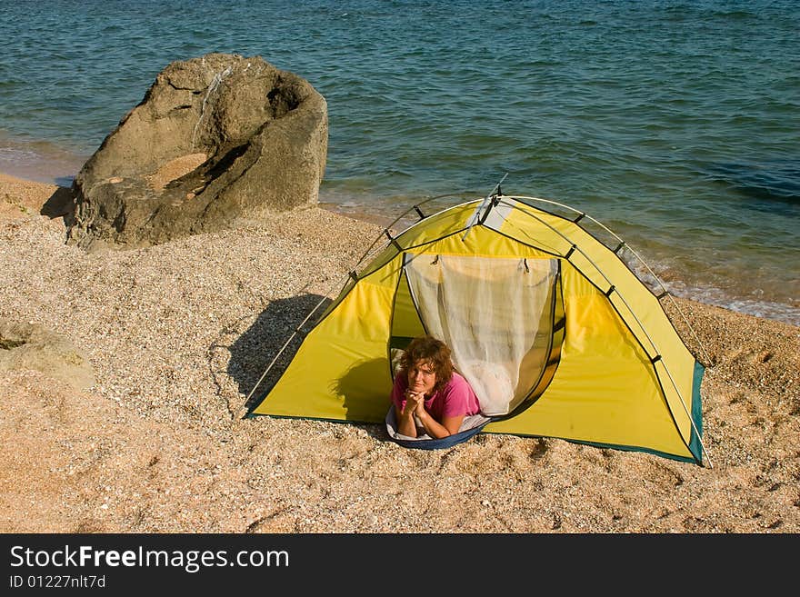 Woman in tent at sand sea beach