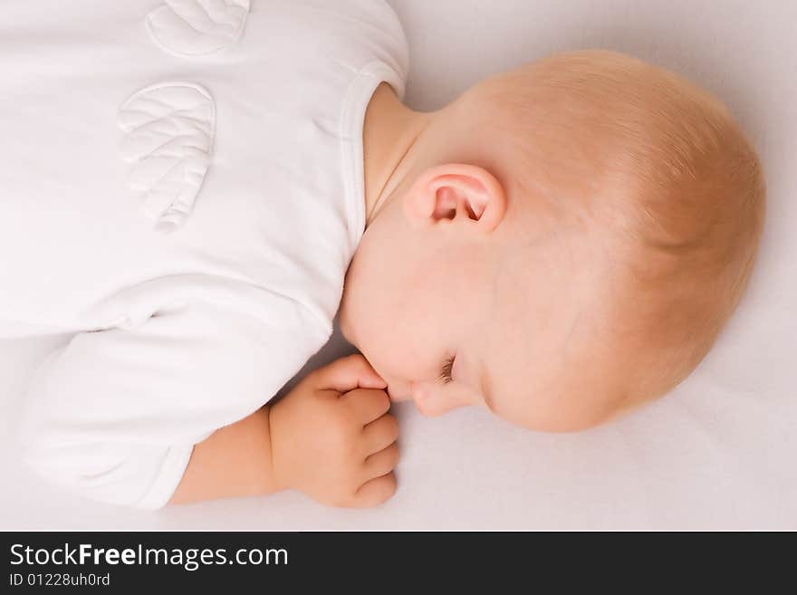 One year old baby boy asleep with angel wings. One year old baby boy asleep with angel wings