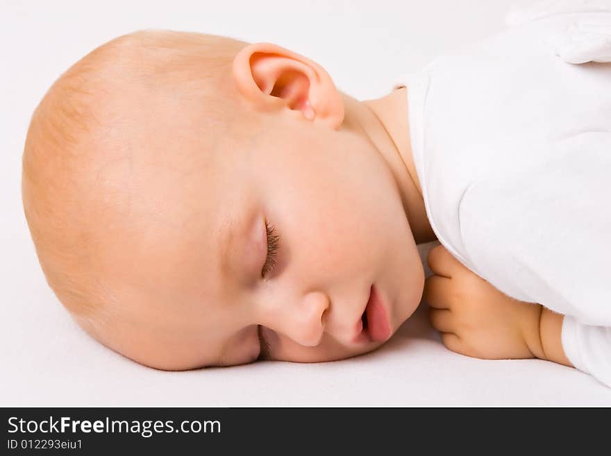 One year old baby boy asleep with angel wings. One year old baby boy asleep with angel wings