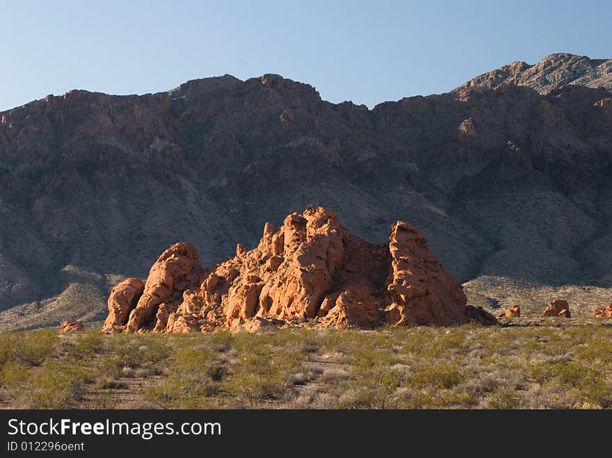 Red rocks called Valley of Fire with the backdrop of black mountains looks like another world. Red rocks called Valley of Fire with the backdrop of black mountains looks like another world.