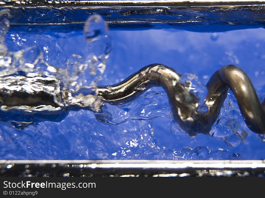 Metal corkscrew on the liquid water drops. Metal corkscrew on the liquid water drops