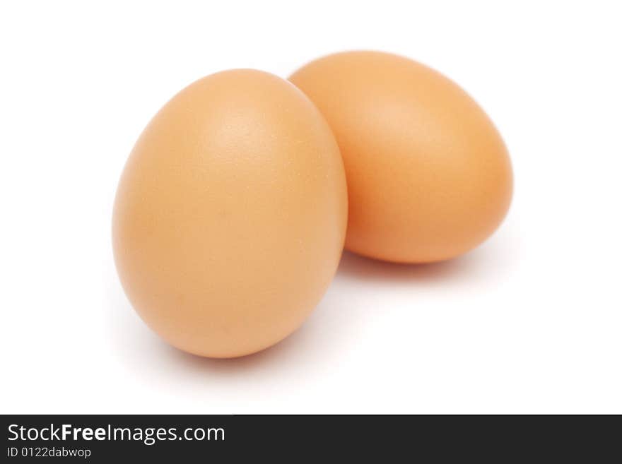 Close up of two eggs on white background.