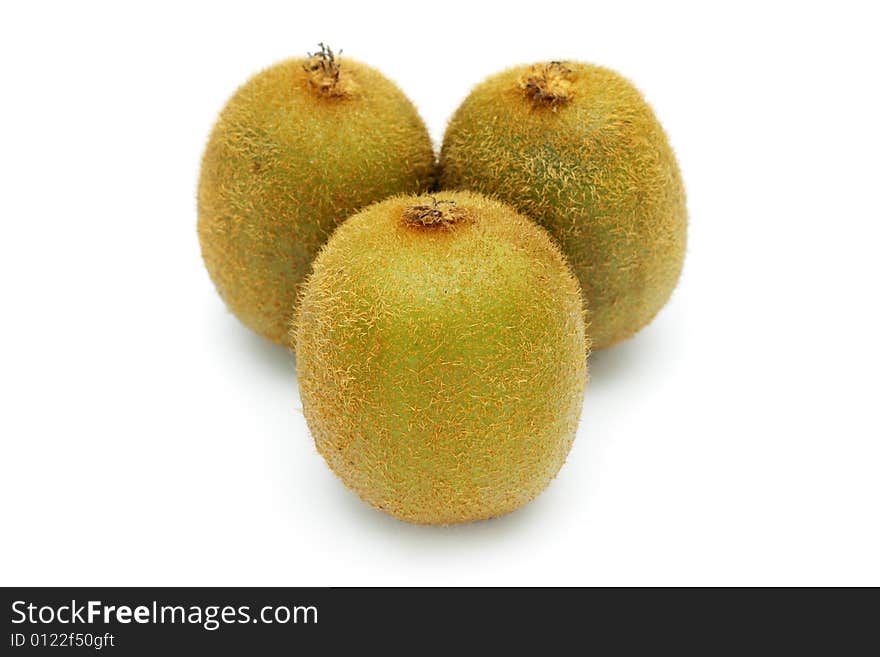 Close up of three kiwi fruits standing on white background.