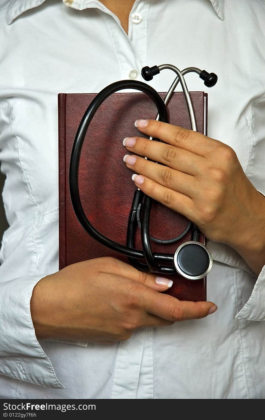 Young female doctor have stethoscope and notebook