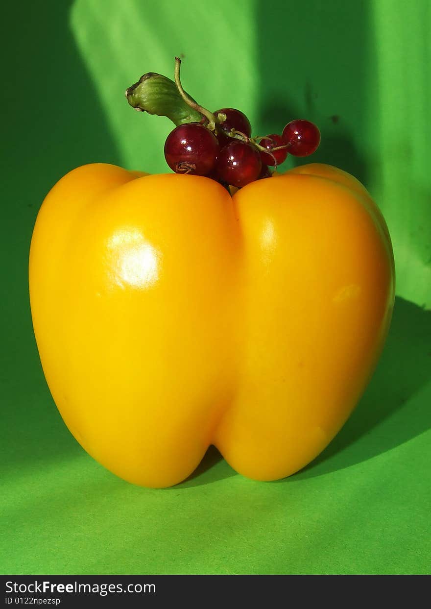 Yellow pepper with a currant