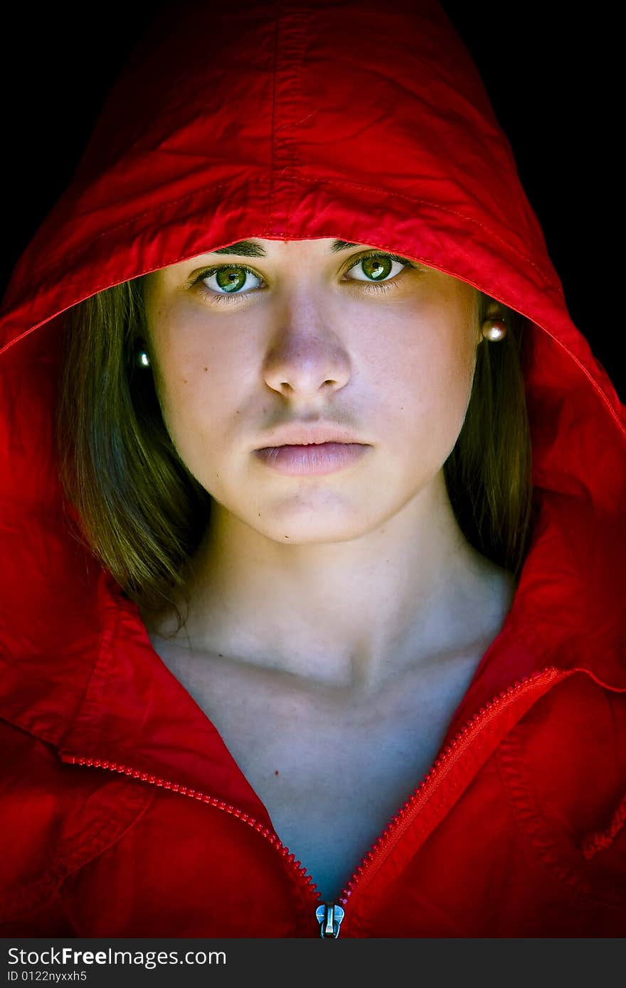 Green eyed beauty protected with a red cap from the dark. Green eyed beauty protected with a red cap from the dark.