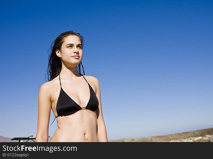 Young beautiful green eyed woman posing under the sun. Young beautiful green eyed woman posing under the sun.