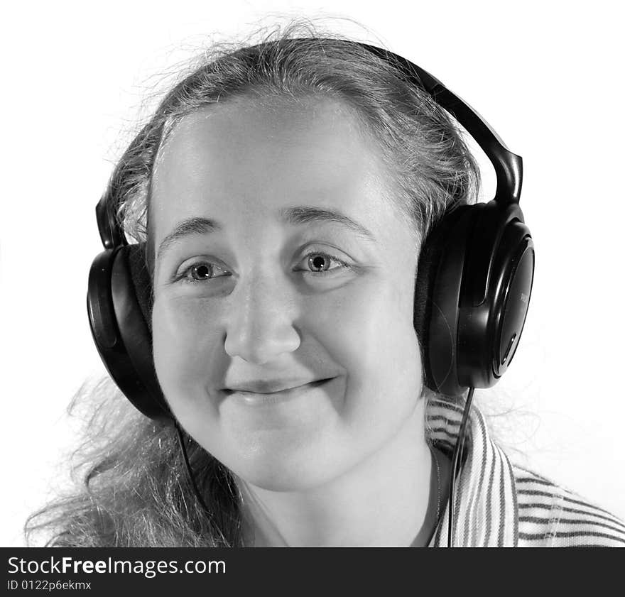 Young woman listening to music on headphones. Isolated on white. Young woman listening to music on headphones. Isolated on white