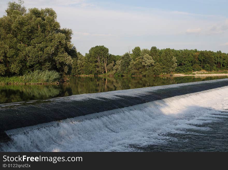 A small river Adda's waterfall in a summer day. A small river Adda's waterfall in a summer day