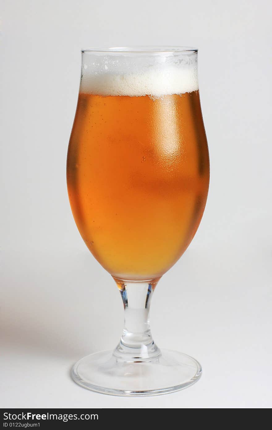 Glass of beer with water condensing on the glass. Glass of beer with water condensing on the glass