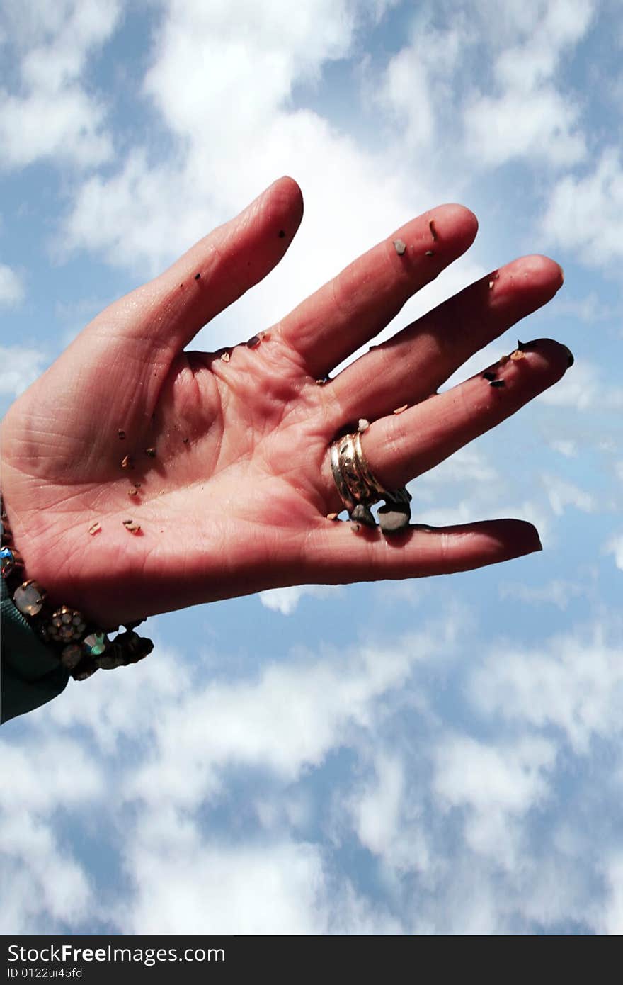 A hand full of earth against a beautiful blue sky. A hand full of earth against a beautiful blue sky