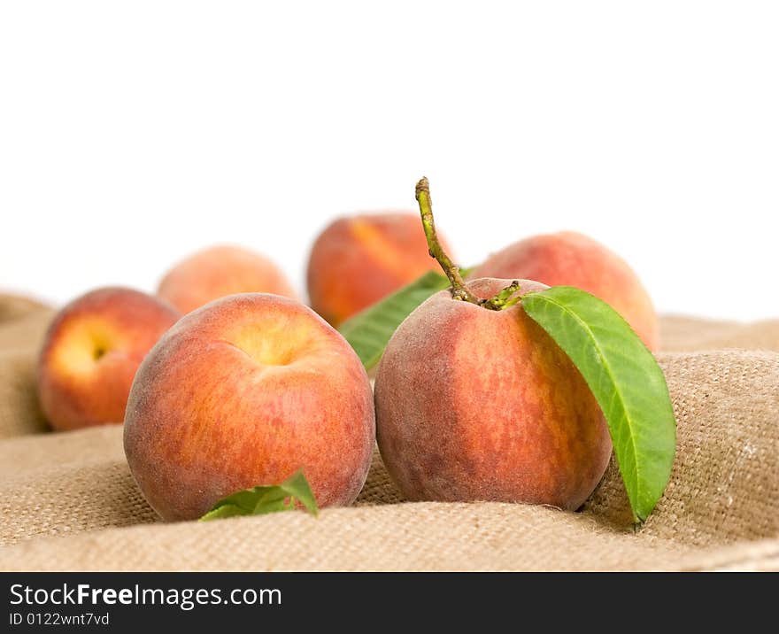 Ripe peaches on burlap texture