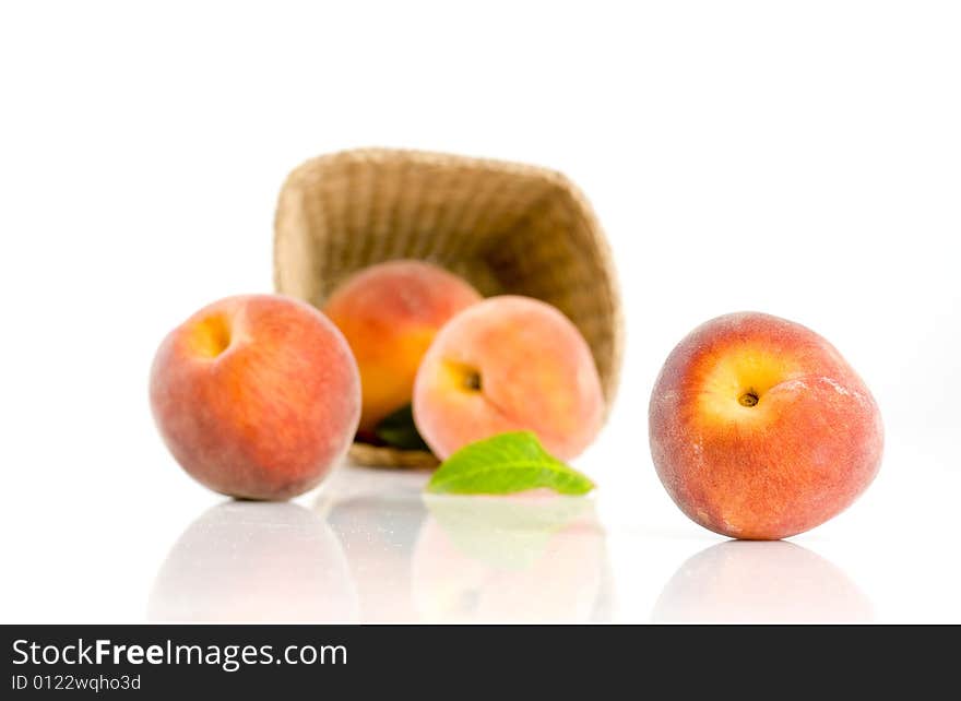 Ripe peaches falling from a basket