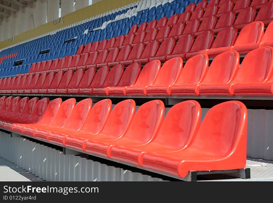 Free Seats on a tribune of stadium of yellow and dark blue color. Free Seats on a tribune of stadium of yellow and dark blue color