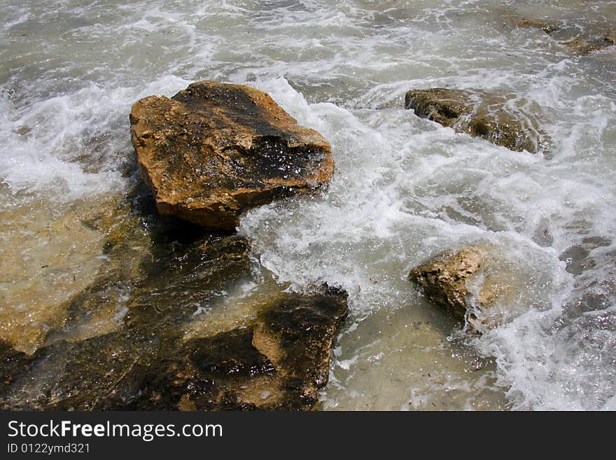 Splash of the waves against the rocks at sea.