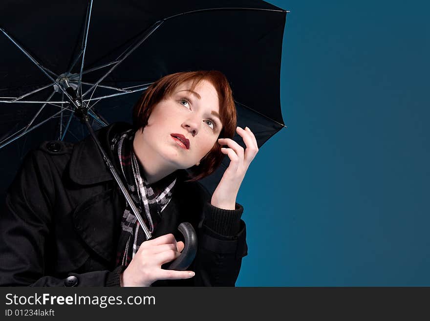 Red haired woman under a umbrella. Red haired woman under a umbrella