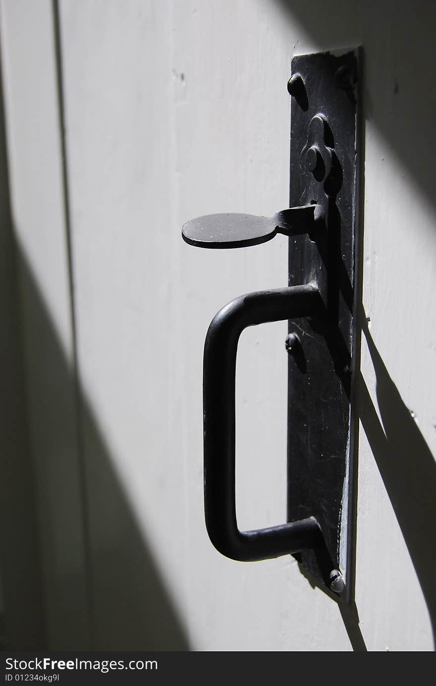 Close up of antique door handle in the sunlight.