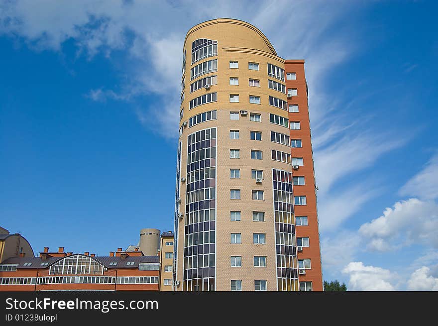 Multistory housing estate of red and yellow bricks in blue sky. Multistory housing estate of red and yellow bricks in blue sky