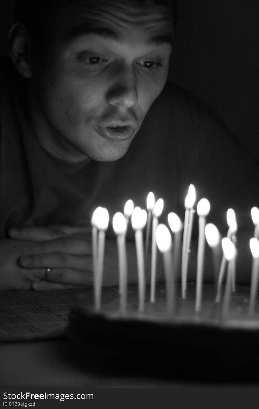 Man's birtday. blowing candles