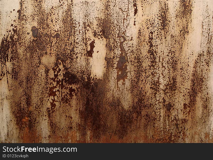 An old rusty damaged fragment on wall. An old rusty damaged fragment on wall